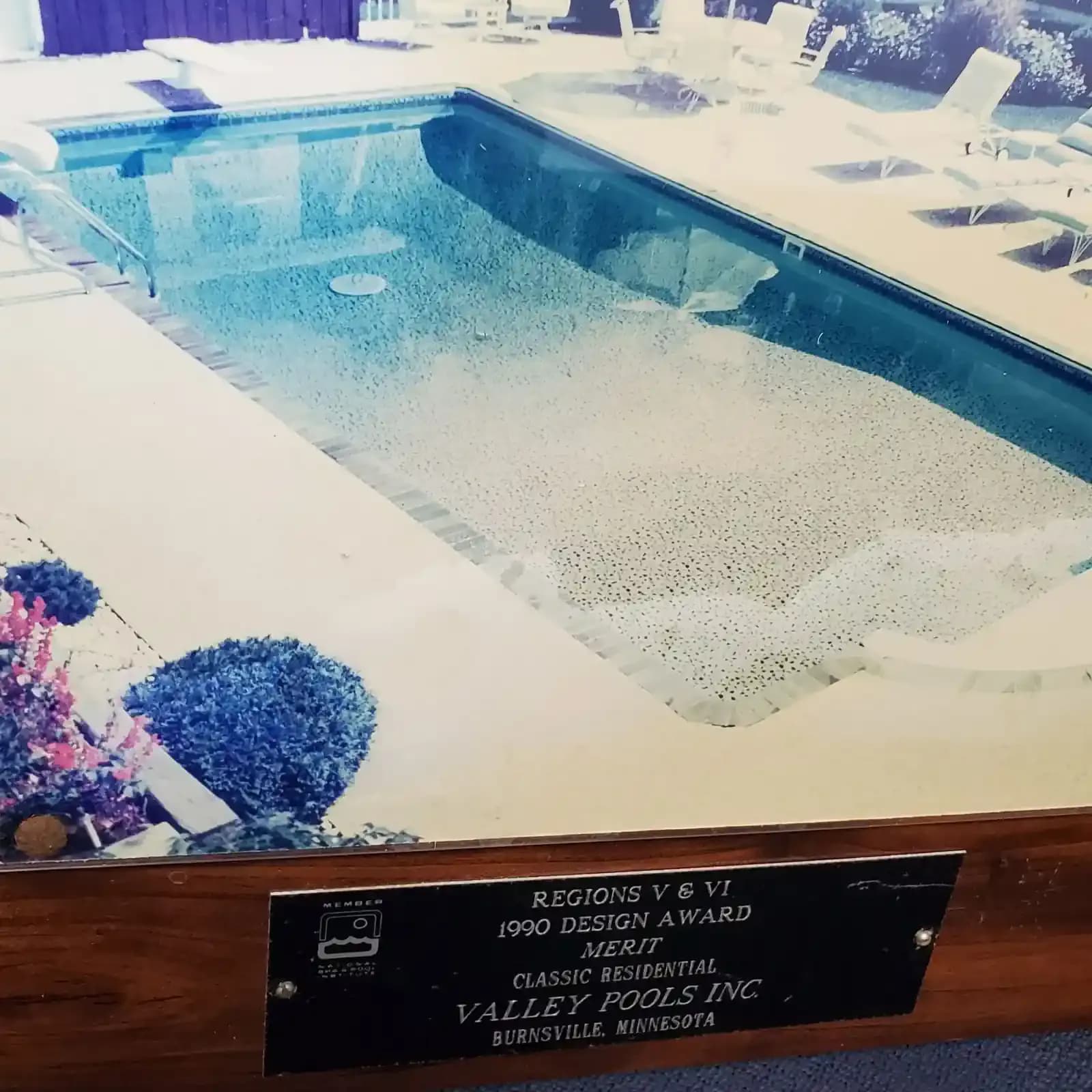 Photo with placard: 1990 Design Award Merit - Valley Pools Inc